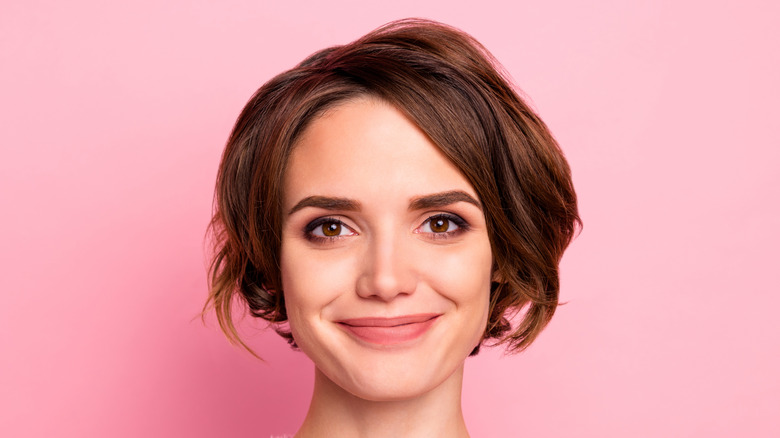 A woman with a bob haircut smiling