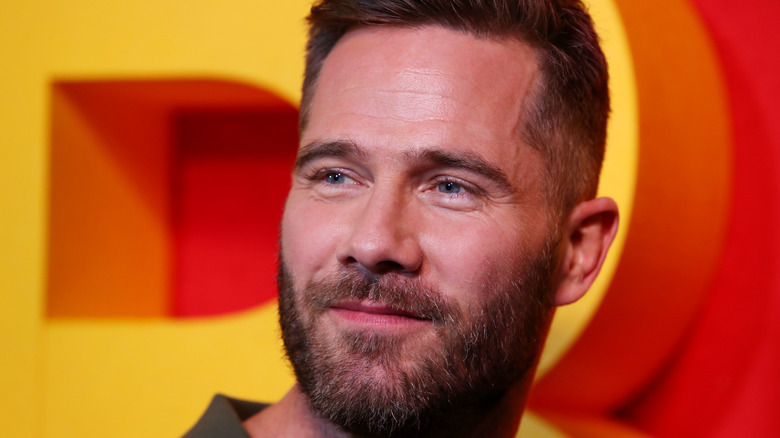 Luke Macfarlane smirking