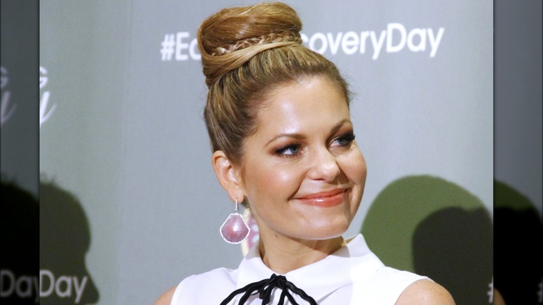 Candace Cameron Bure with a very tall donut bun