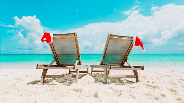 Chairs on beach with Santa hats 