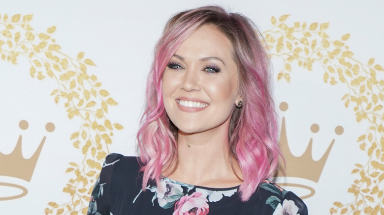 Emilie Ullerup smiling with pink hair