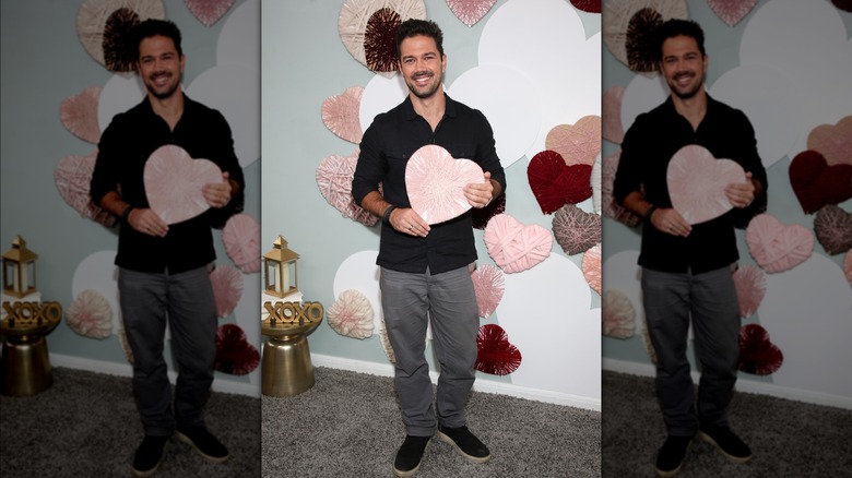 Ryan Paevey holding pink heart