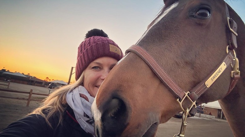 Alison snuggles with her horse 