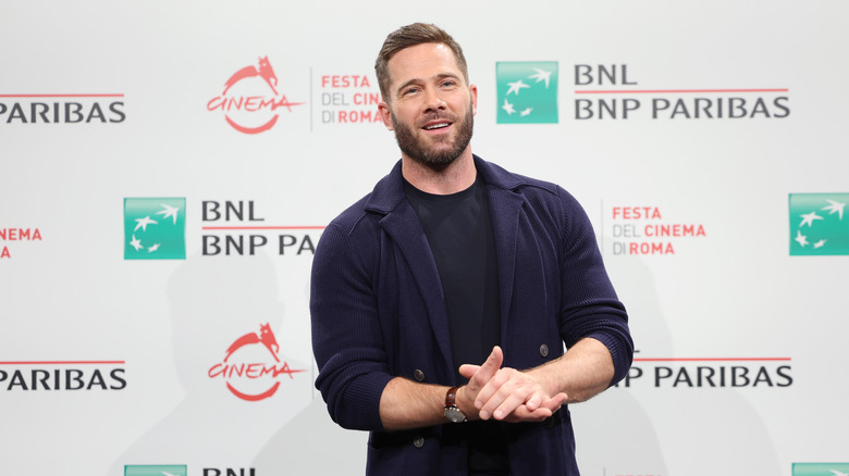 Luke Macfarlane smiling on the red carpet