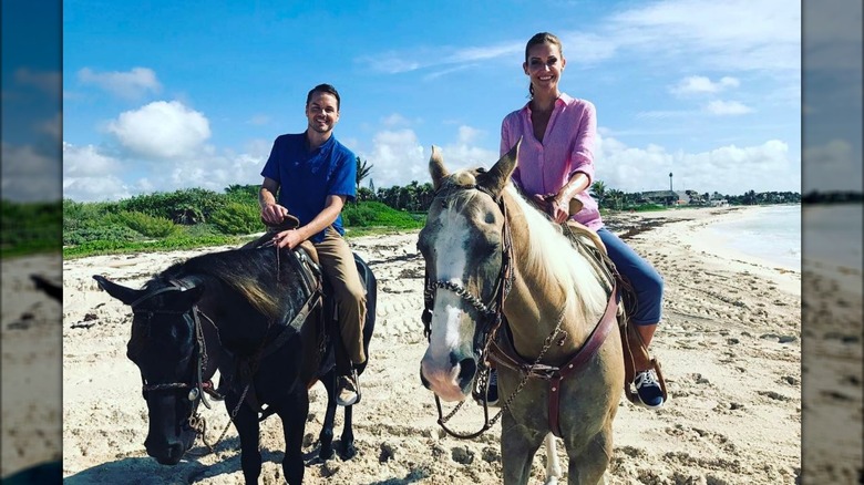 Paul Campbell and Tricia Helfer riding horses