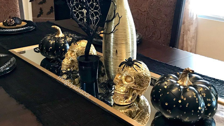 black and gold decorations on a halloween table