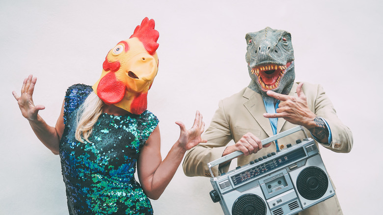 Chicken and t-rex masks while dancing