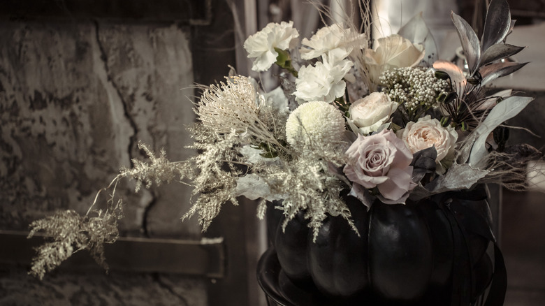 Flowers in a black pumpkin