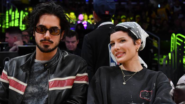 Halsey smiling while sitting next to Avan Jogia