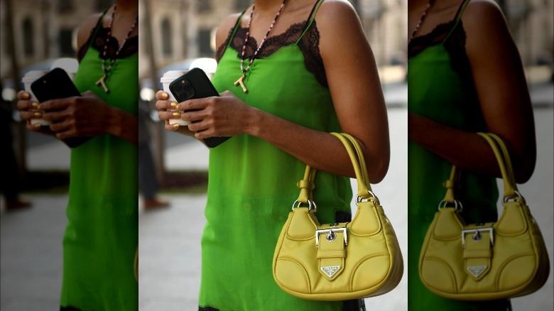 Woman carrying small yellow handbag