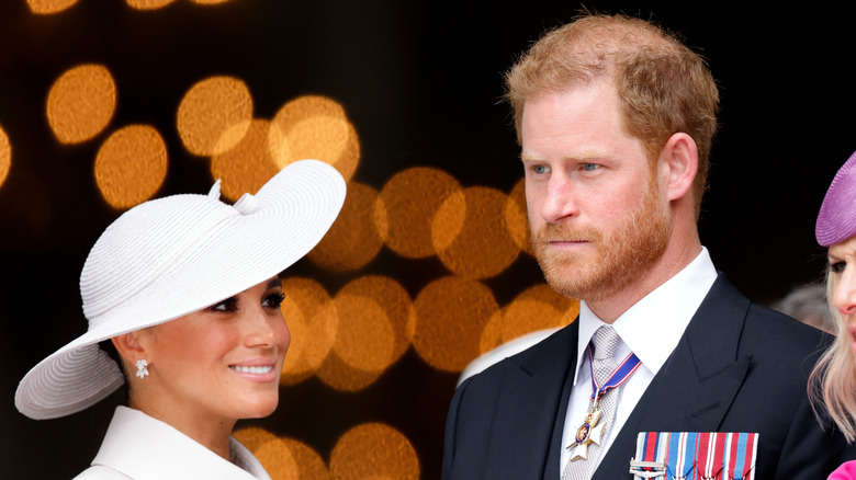 Meghan Markle smiling alongside Prince Harry