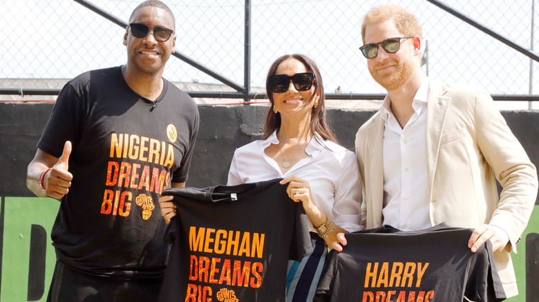 Harry and Meghan pose with individual in Nigeria 