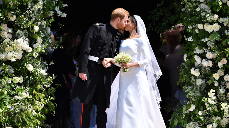 Prince Harry and Meghan Markle kiss and hold hands on their wedding day