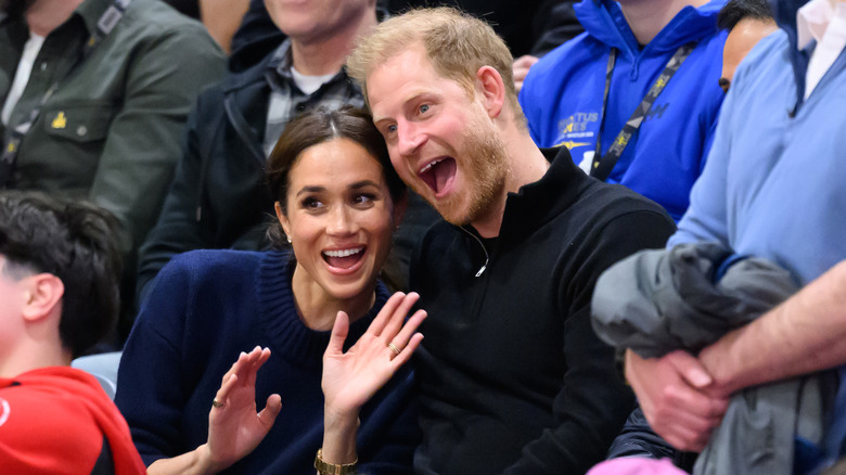 Prince Harry and Meghan Markle smiling for cameras