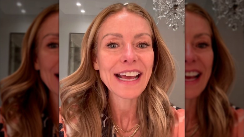 Kelly Ripa smiling in her bathroom mirror