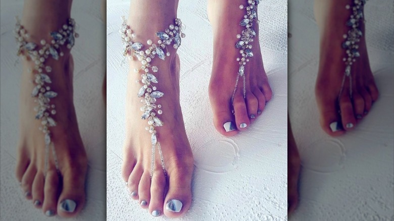 Bride wears bedazzled foot accessory