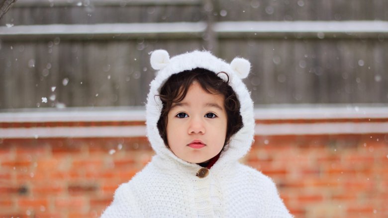 toddler in bear hood in snow