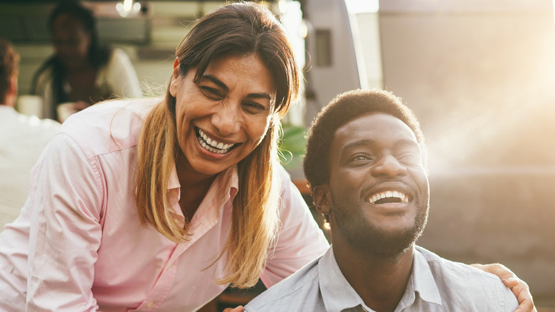 man and woman smiling outside