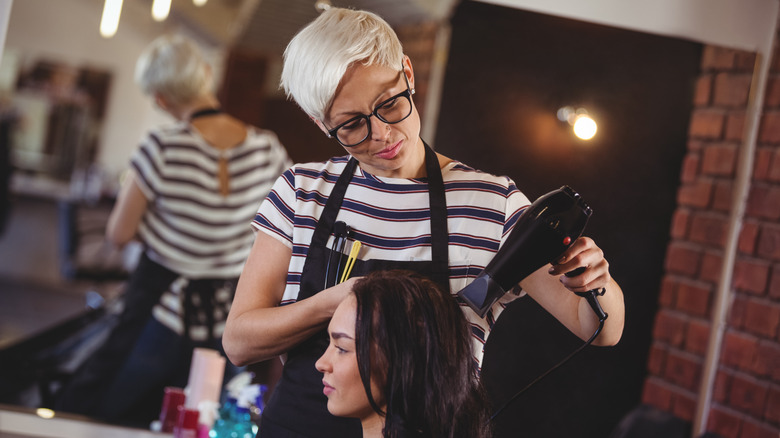 woman getting hair blow dried 