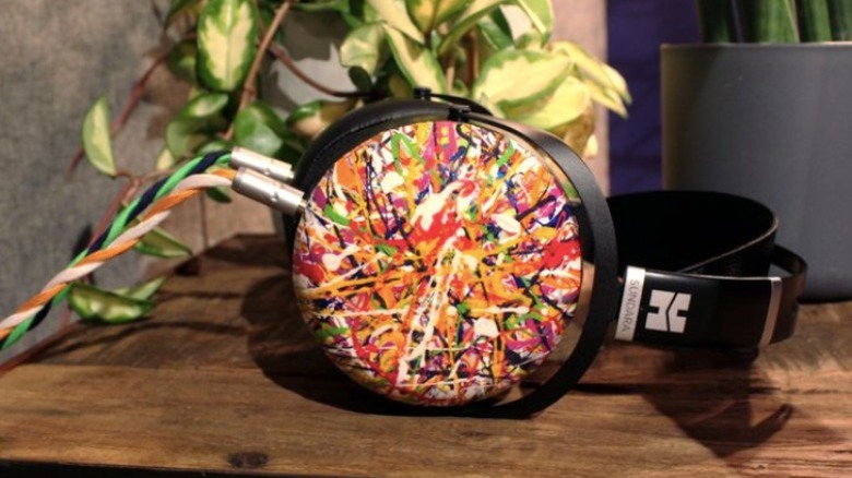 paint splatter headphones on wood table