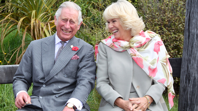 King Charles and Queen Camilla laughing