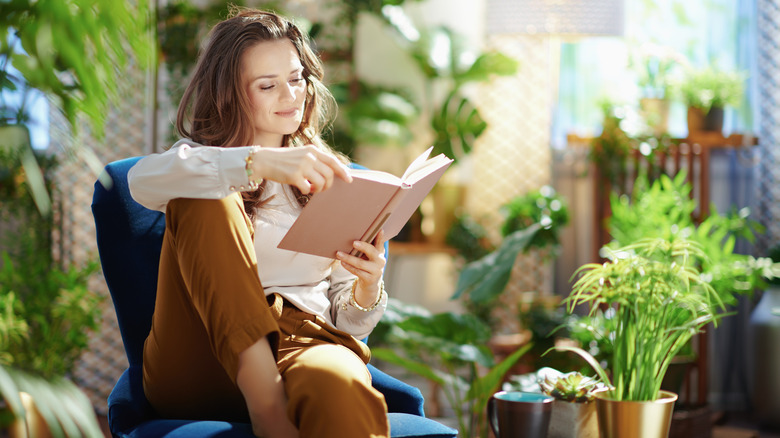 woman reading with plants