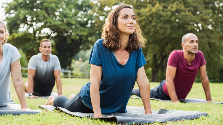 group doing yoga outdoors