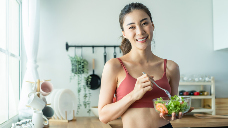 pretty woman eating salad