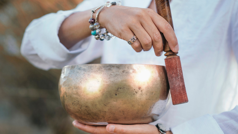 holding tibetan singing bowl