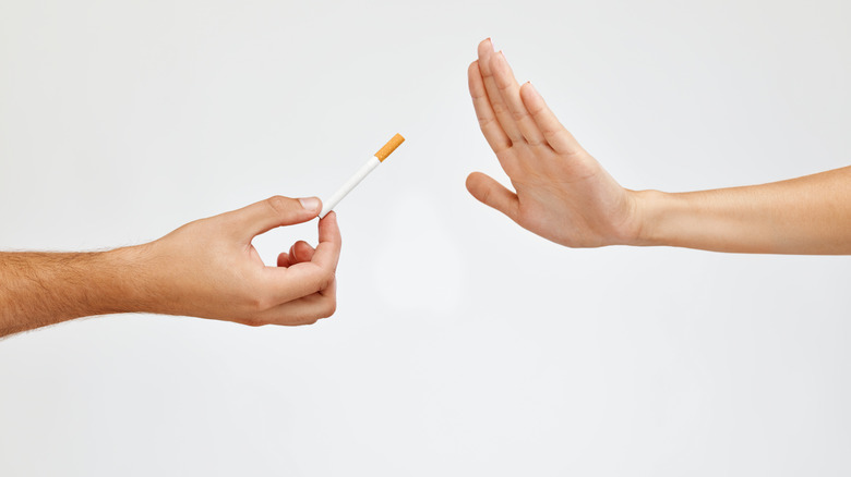 Woman's hand turning down a cigarette