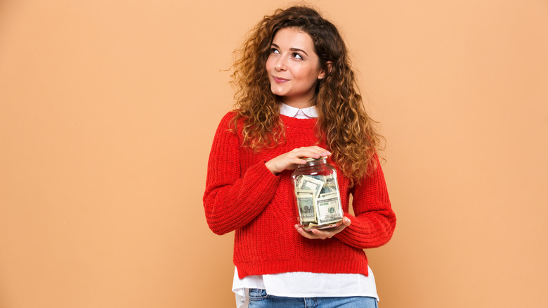 Woman with jar of money