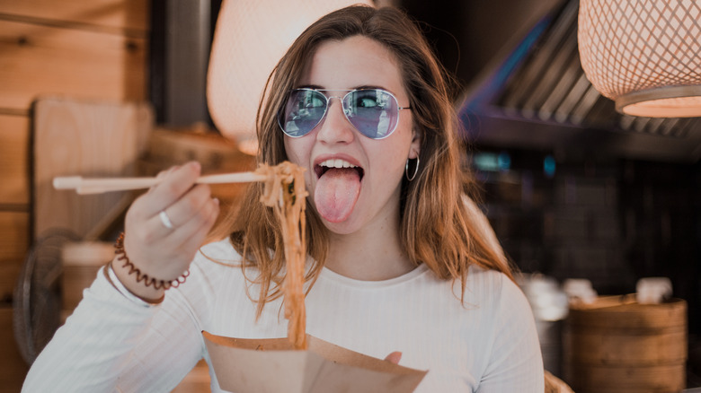 Woman eating noodles