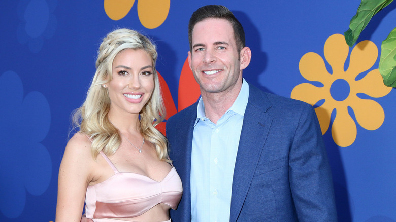 Heather Rae Young and Tarek El Moussa embracing on red carpet 