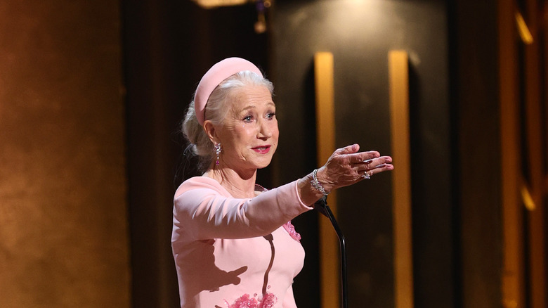 Helen Mirren gesturing to her fellow actors from the stage