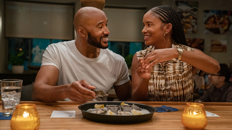 Henry Simmons and Joy Bryant smiling at each other in "Cherish the Day"