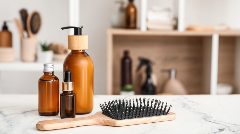 Brown skincare bottles and hairbrush