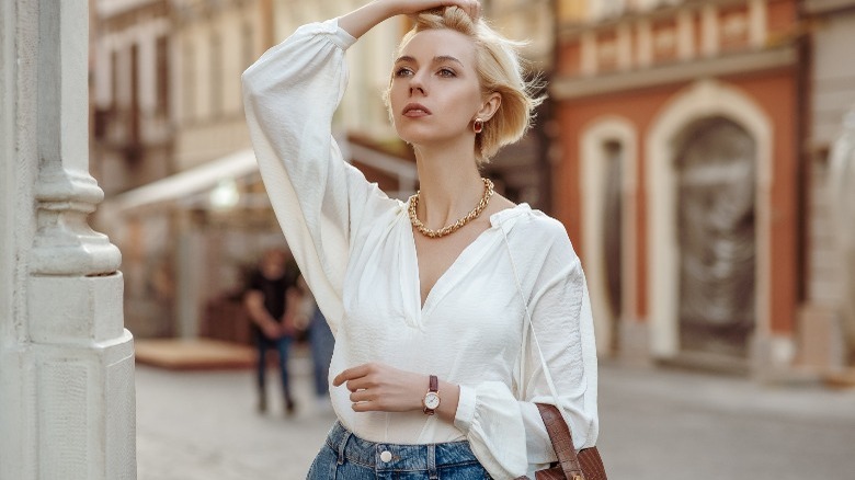 woman loose white blouse jeans