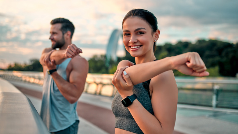 A couple stretching pre-run