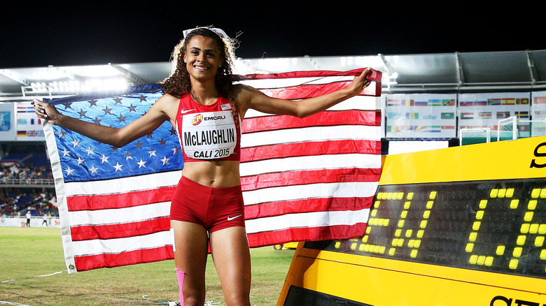 Sydney McLaughlin-Levrone holding flag at meet