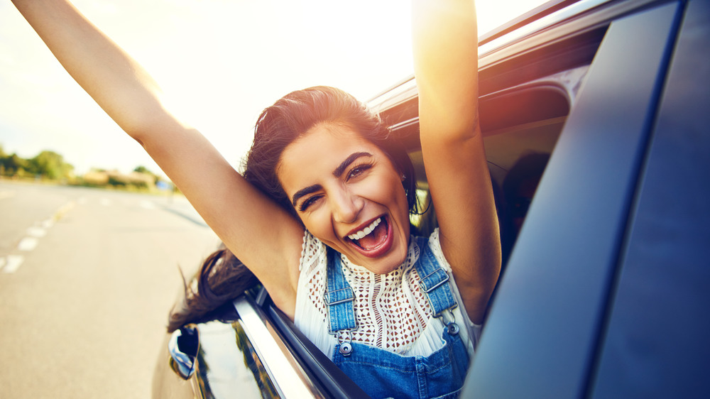 Girl smiling in car