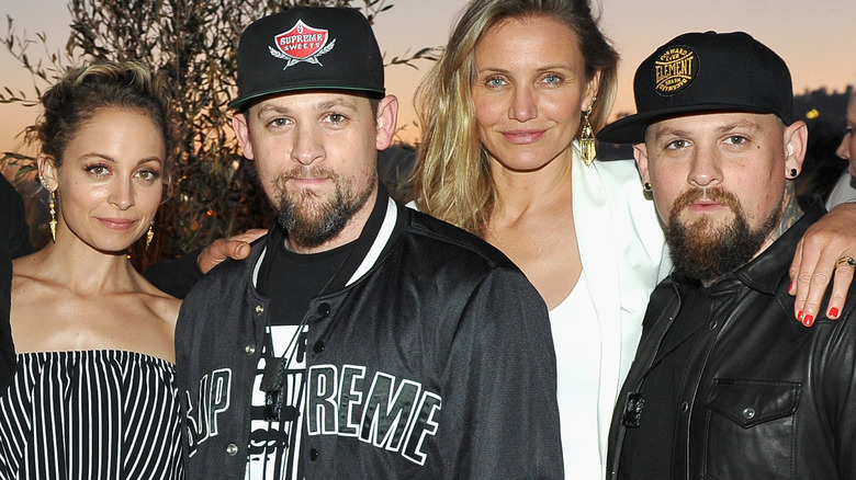 Cameron Diaz and Nicole Richie posing for a picture with their husbands Benji and Joel Madden