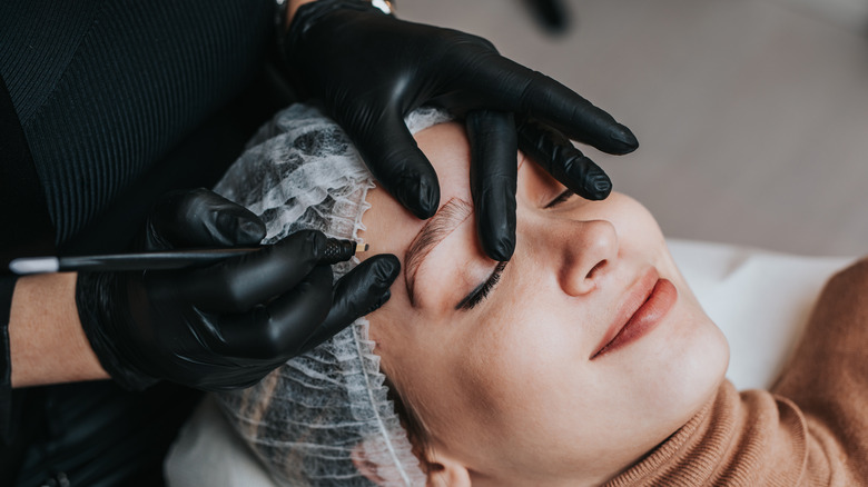 woman having microblading procedure