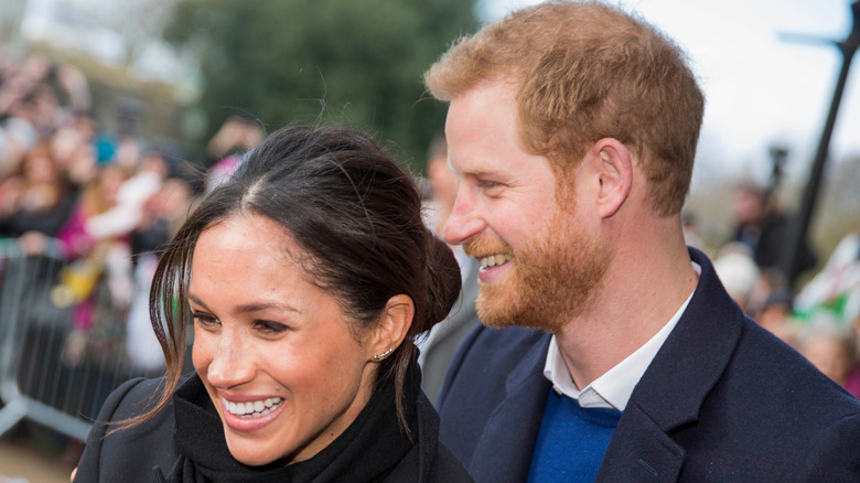 Prince Harry smiling with Meghan Markle