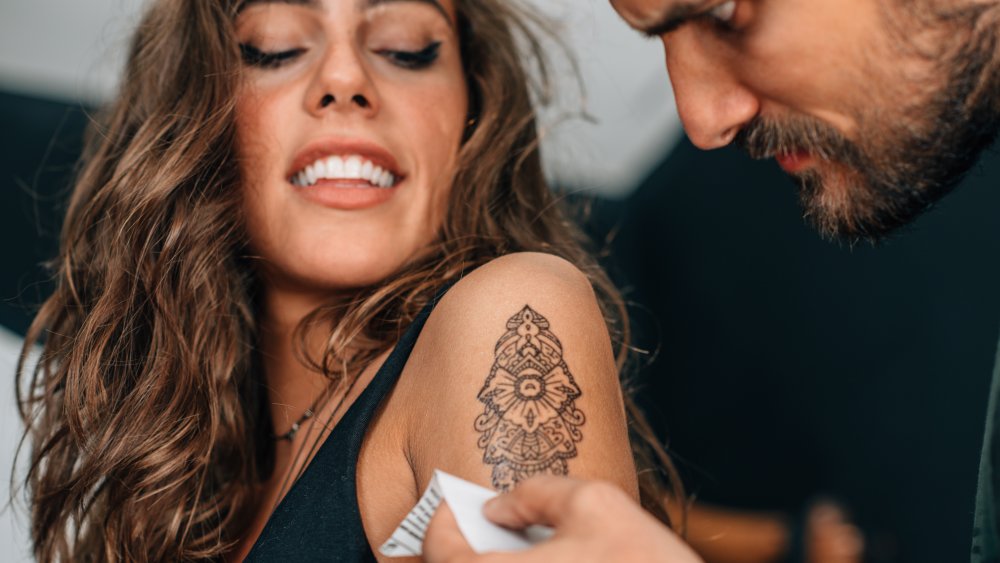 Woman getting a tattoo