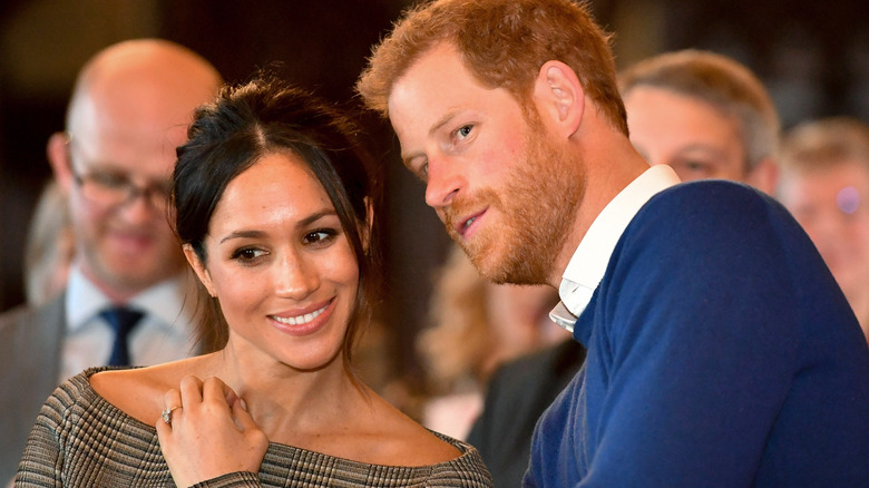 Meghan Markle and Prince Harry confer about something