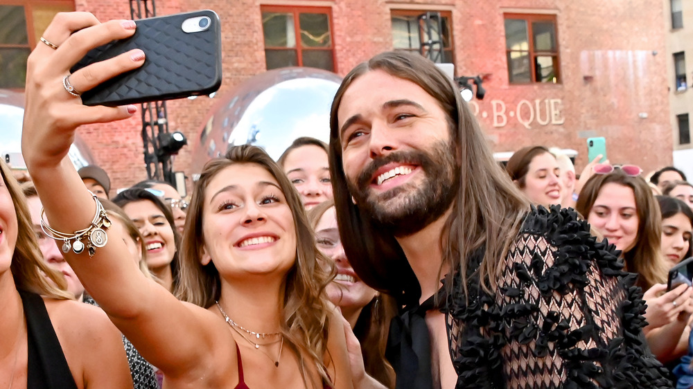 Jonathan Van Ness taking a selfie with a fan