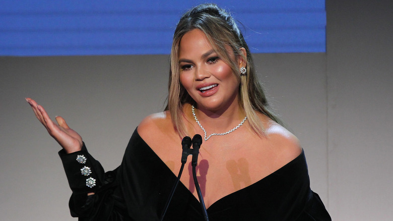 Chrissy Teigen speaks onstage at an event