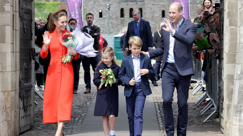 Royal family exiting castle and waving