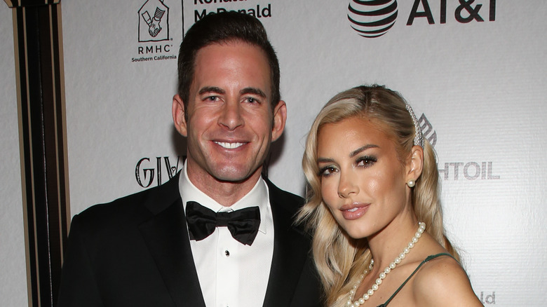 Tarek El Moussa wears a bow tie with Heather Rae Young in pearls.