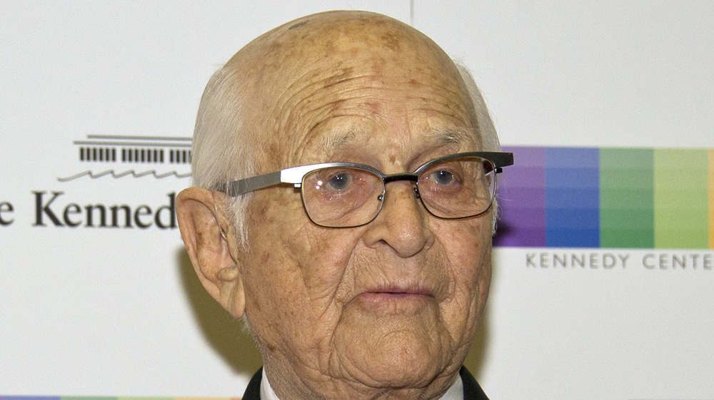 Norman Lear crosses his arms at an event